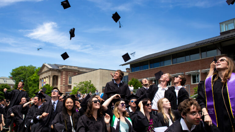 Seniors toss their graduation caps in the air on Commencement day