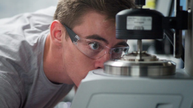 A student examines equipment in a chemistry lab