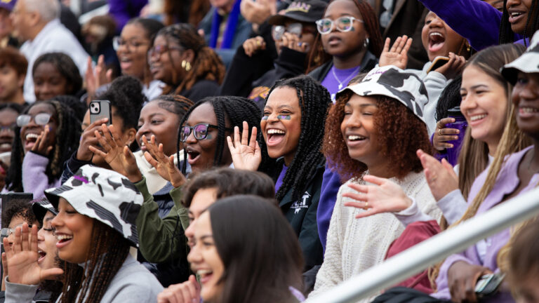 Students in the stands cheer for the Williams football during homecoming