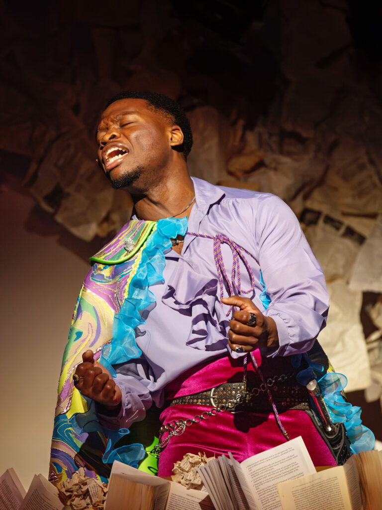 A student theater performer photographed mid-performance