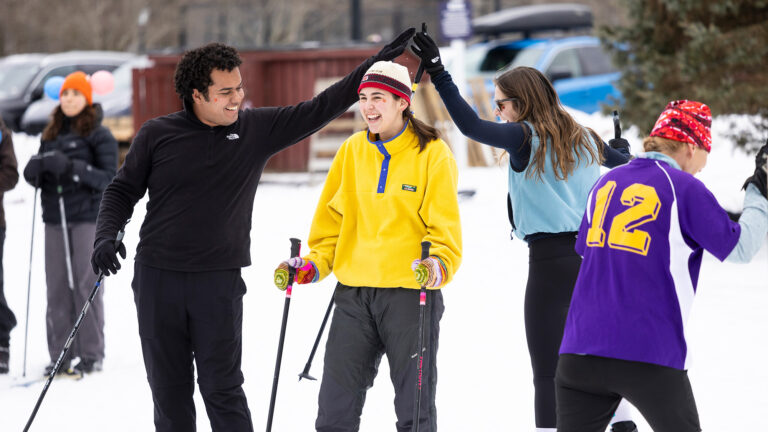 A group of students wearing skis at Winter Carnival