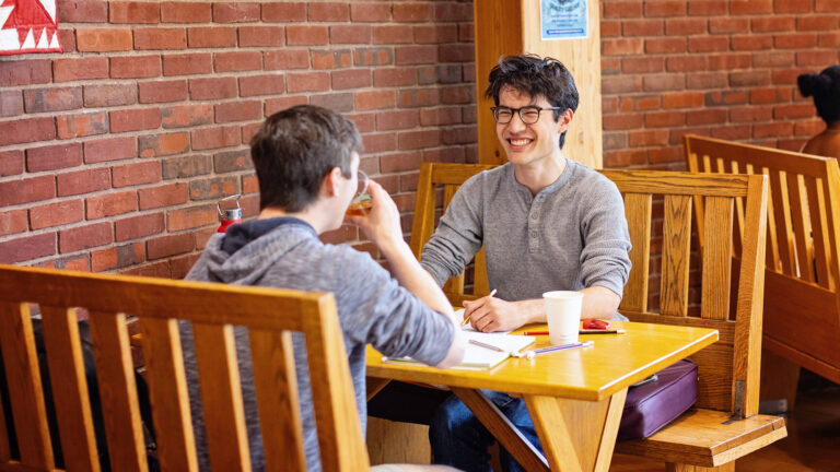 Two students having a conversation and studying in the Paresky Center