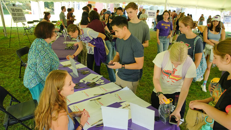Students engaging with presenter tables at a career fair
