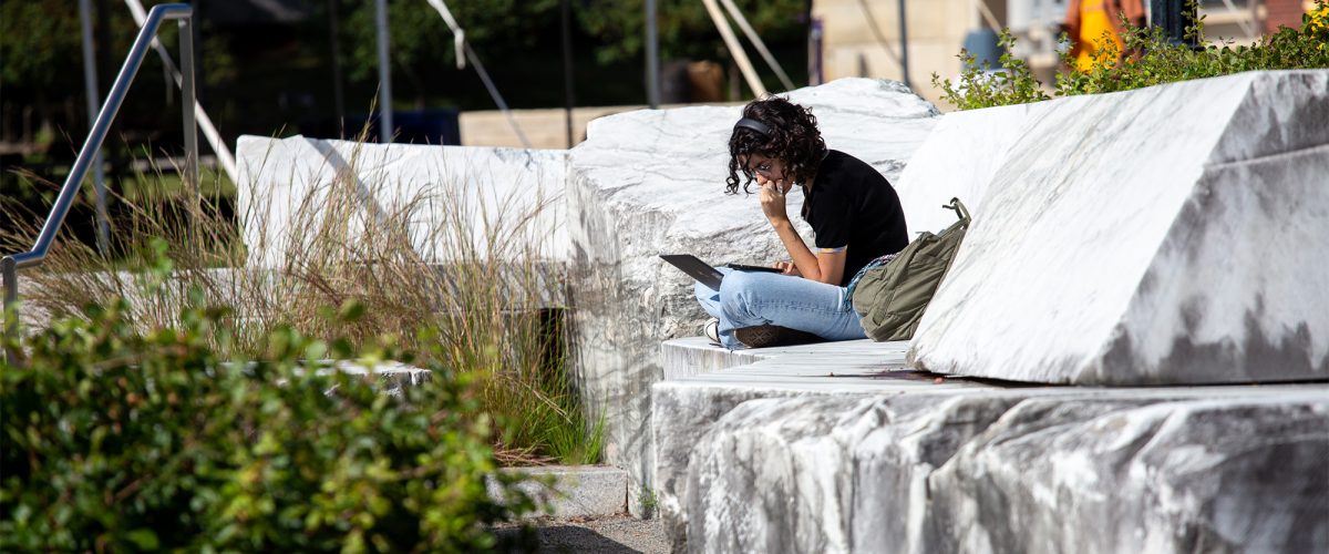 Student studying while sitting on marble slabs