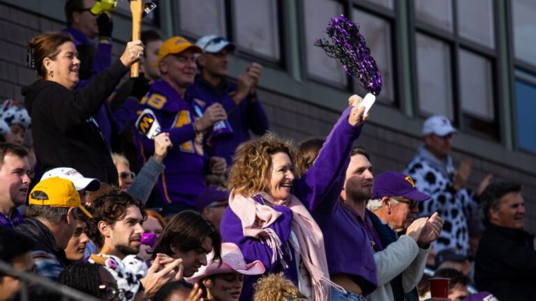 Fans cheering on the Williams football team at Homecoming