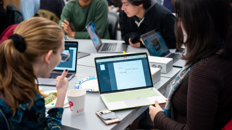 Students working together on laptops in a classroom