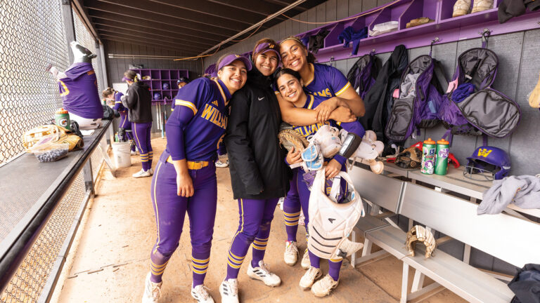 the women's softball team, arm in arm