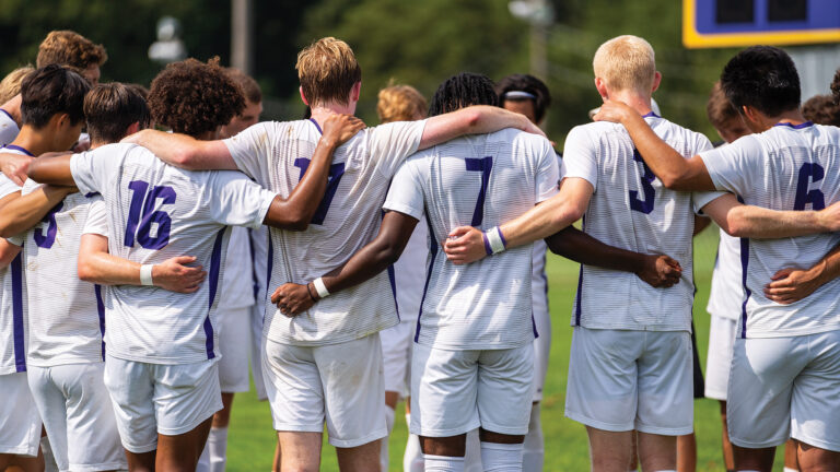 a sports team in a huddle