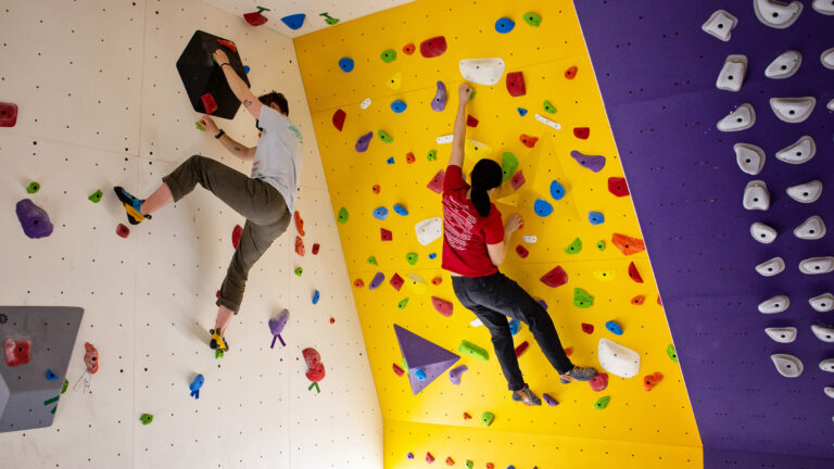 Students using an indoor climbing wall