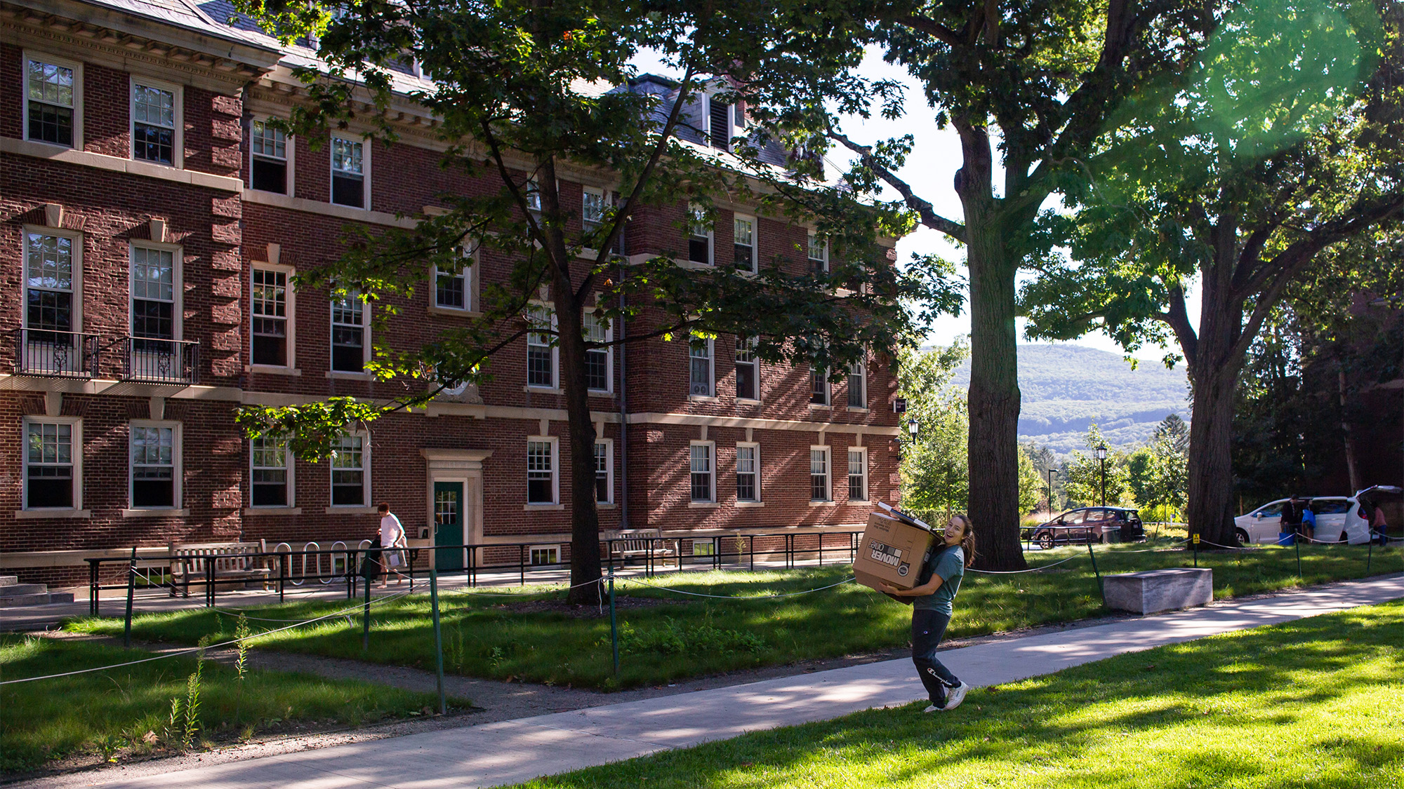 Student carrying a box during move-in in the Frosh Quad