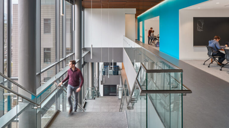 A student walking up the stairs in the science center