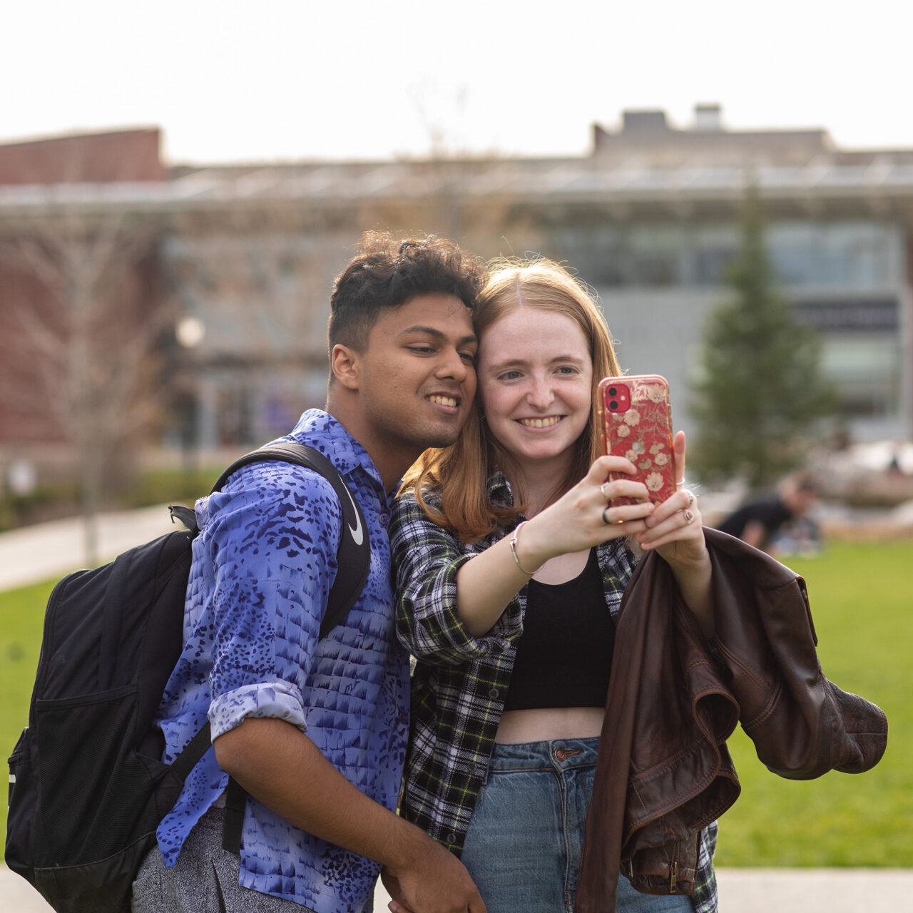 two students taking a selfie by the quad