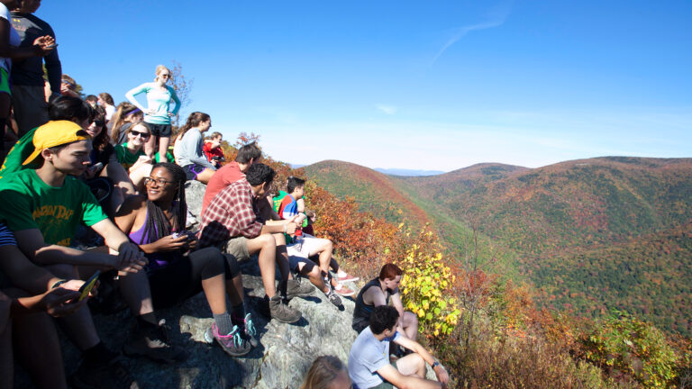 students on stone hill during mountain day