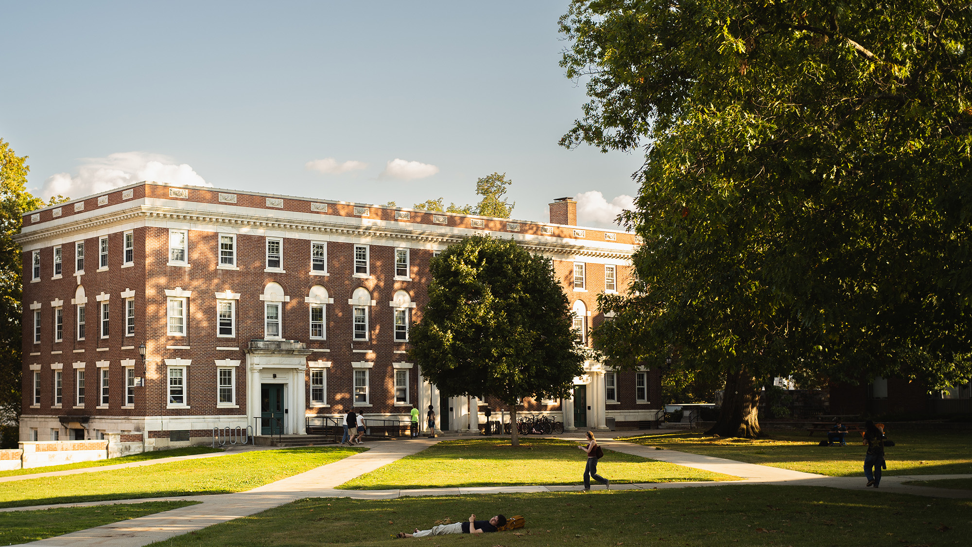 Student laying down in the grass of the Berkshire Quad