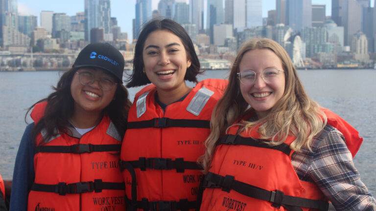 Students wearing life jackets on a boat near New York City during the CaOS Climate and Community Leaders program