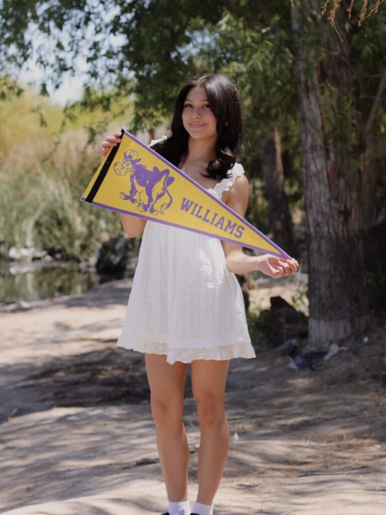 A student holding a Williams pennant
