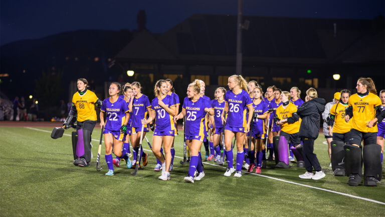 The Williams' field hockey team walking together on the field