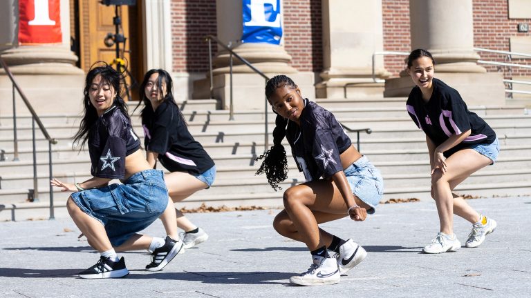 Four student dancers performing in front of Chapin Hall