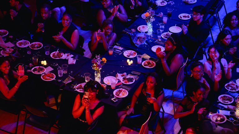 A large group of students sitting at tables having a meal as part of a BSU event