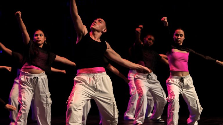 A group of student dancers performing on-stage