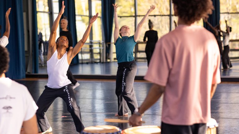 Students rehearsing in a dance studio