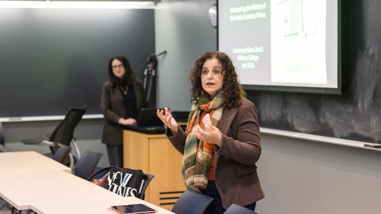 A professor introducing Karen Zraick prior to a guest lecture