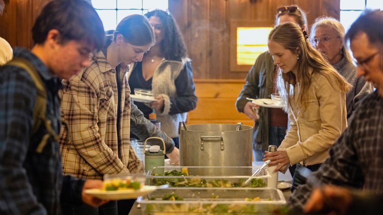 Students serve themselves in a buffet line at a Log Lunch
