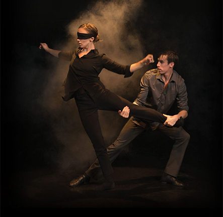 Two dancers performing in low light and smoke, cover image for Visiting Artist: Cas Public Dance 