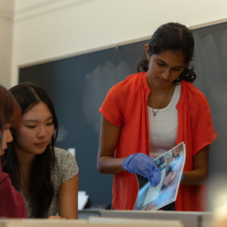 Two students with working with Archive paper materials