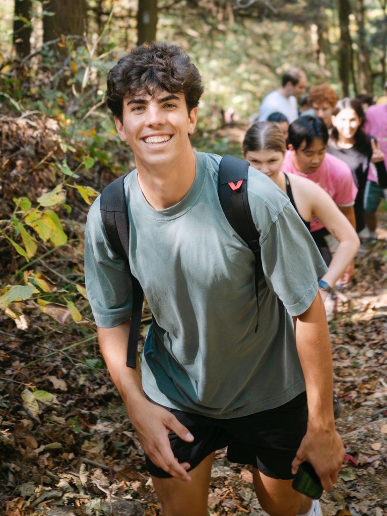 student hiking in the woods