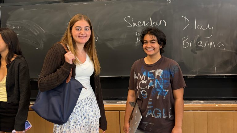 Program in Teaching students posing in front of a blackboard