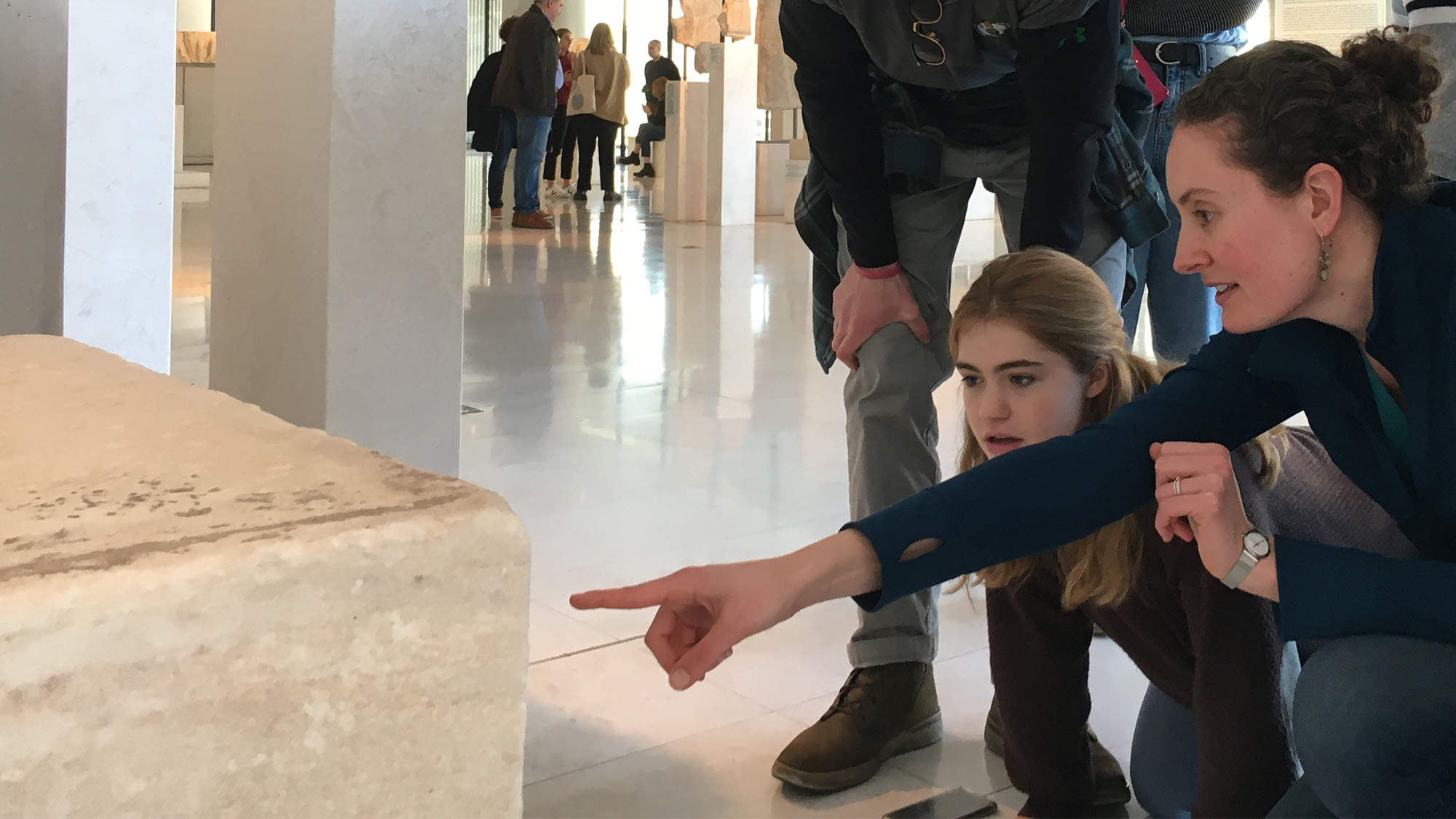 Classics students on Study Abroad in Greece examining artifacts in a museum
