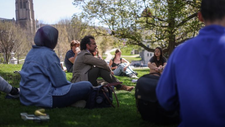 a professor leading a class outdoors