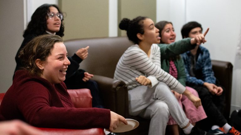 Students enjoying snacks and conversation in a dorm common area