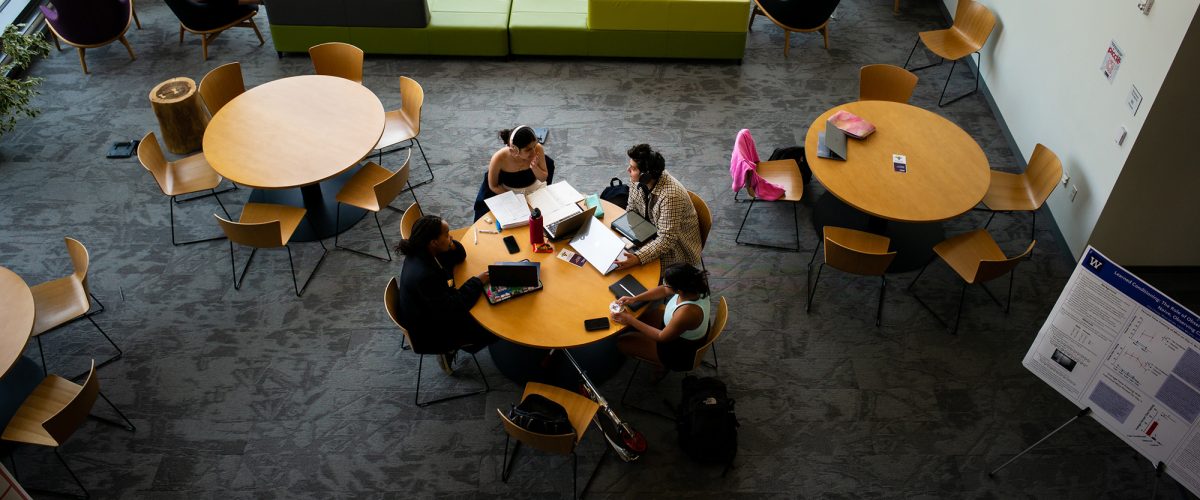Psychology students study around a table in the science library