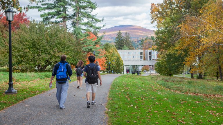 students walk towards the mission park dorm against a dramatic backdrop of the Berkshires