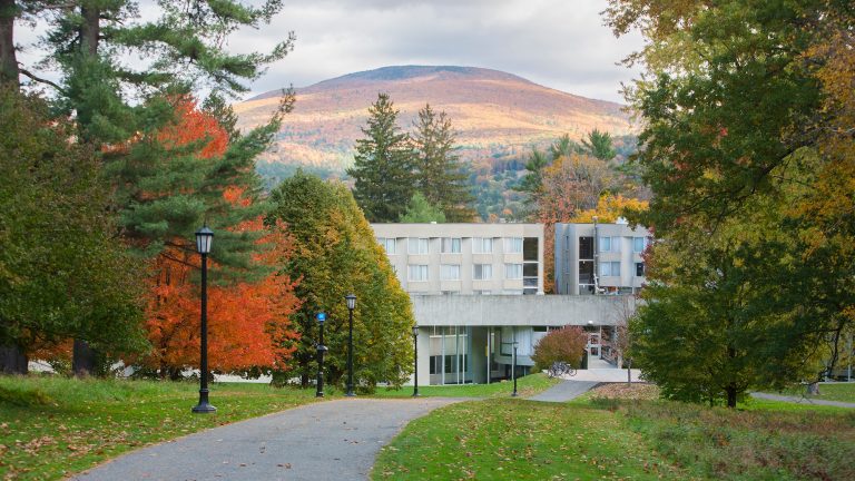 The Mission dormitory against a backdrop of the mountains in the fall