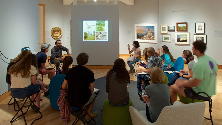 A group of students listening to a professor in Object Lab at the Williams College Museum of Art