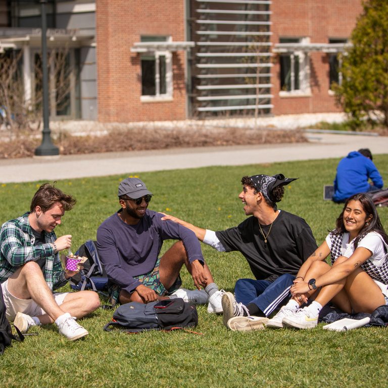 Students sitting outside on the quad