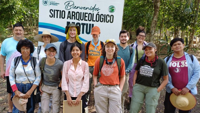 Williams College students and faculty members posting for a photo at an archaeological dig in Guatemala